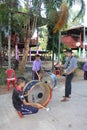 Asian teacher is teaching the music note for student group.